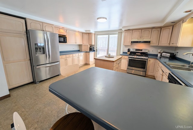 kitchen with light brown cabinetry, a center island, sink, and black appliances