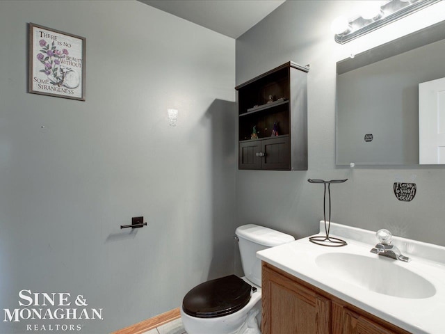 bathroom featuring vanity and toilet