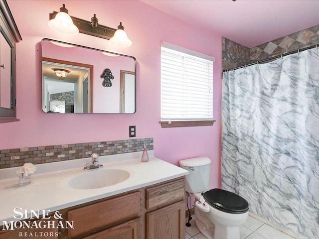 bathroom with curtained shower, decorative backsplash, tile patterned flooring, vanity, and toilet