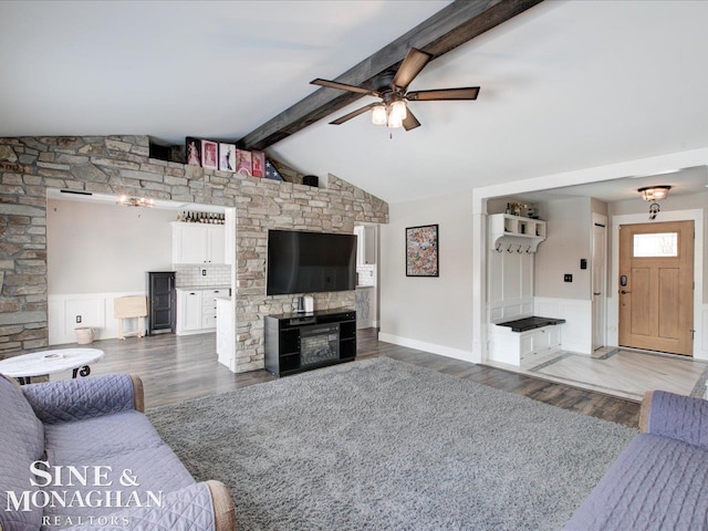 living room featuring a fireplace, lofted ceiling with beams, dark hardwood / wood-style floors, and ceiling fan