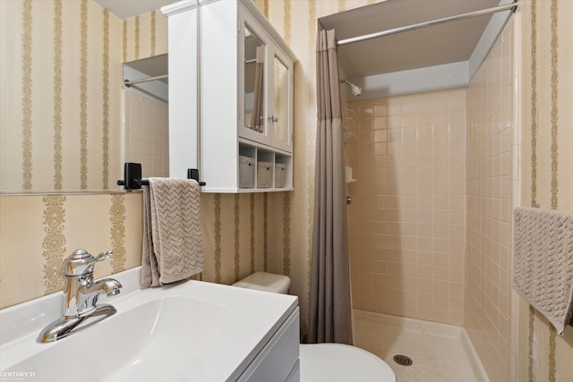 bathroom featuring toilet, vanity, and walk in shower