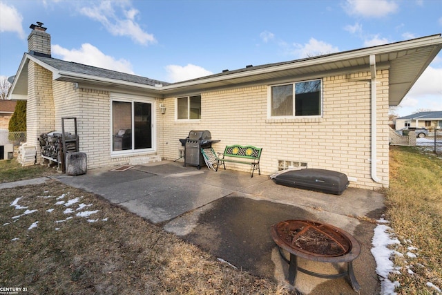 back of house featuring a patio area and an outdoor fire pit