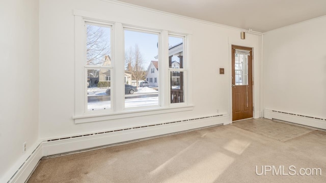 interior space featuring crown molding, a baseboard heating unit, and carpet flooring