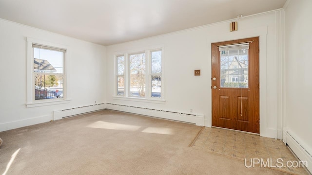 carpeted entryway with ornamental molding and a baseboard heating unit