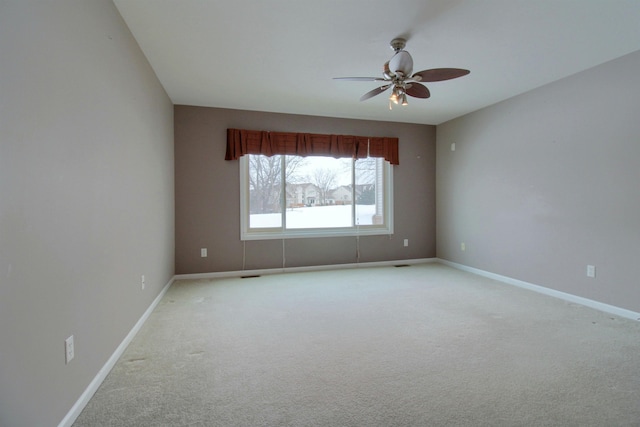 carpeted spare room featuring ceiling fan