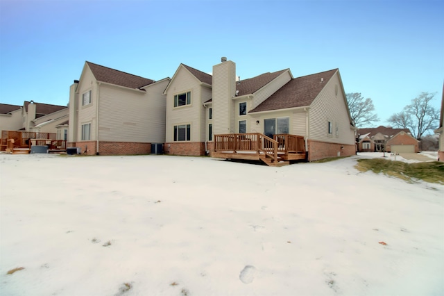 snow covered property featuring a wooden deck