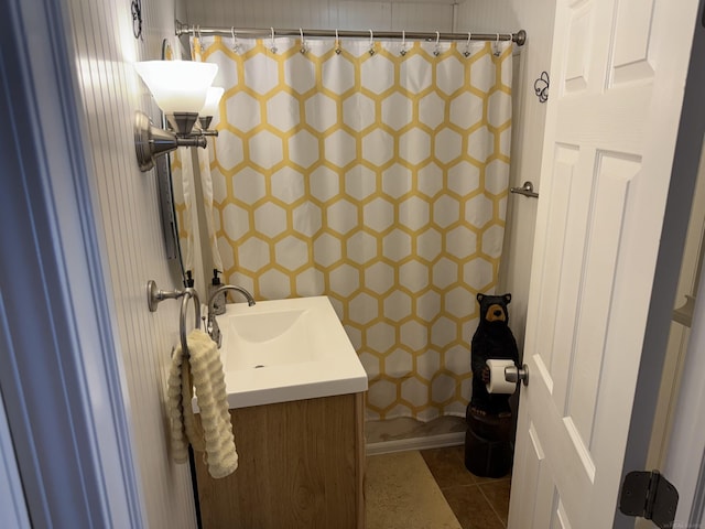 bathroom with walk in shower, vanity, and tile patterned flooring