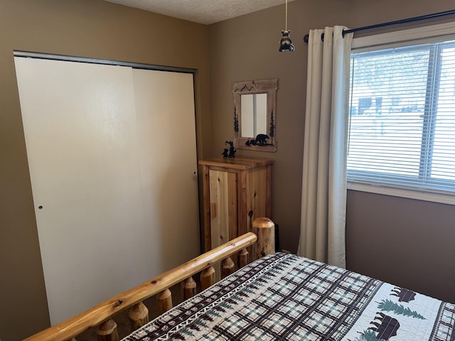 bedroom with a closet and a textured ceiling