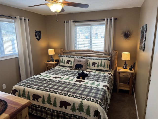 carpeted bedroom featuring multiple windows and ceiling fan