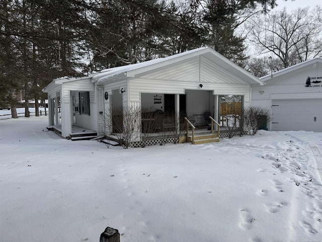 view of front of house featuring a porch and a garage