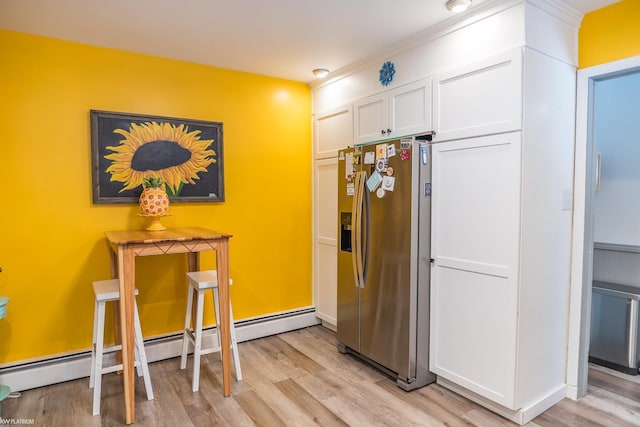 kitchen featuring stainless steel refrigerator with ice dispenser, light hardwood / wood-style floors, and white cabinets