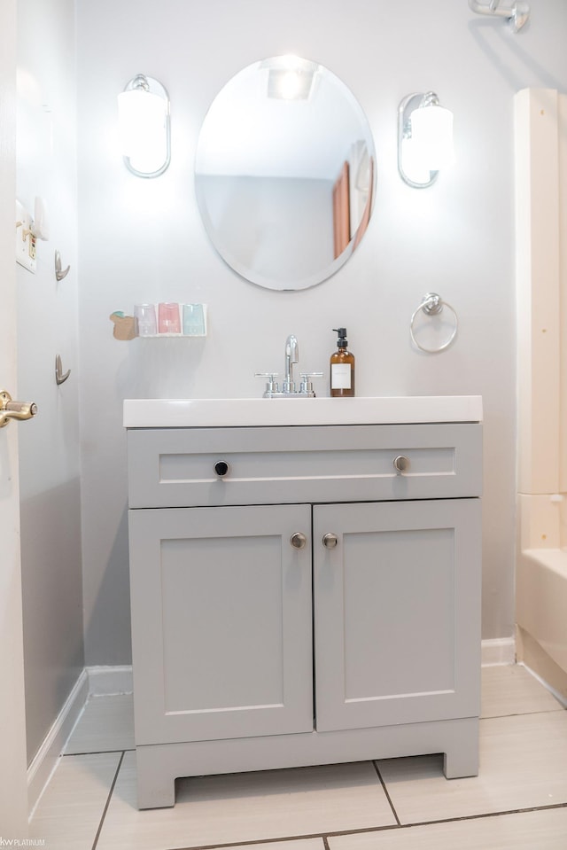 bathroom with vanity and a bath