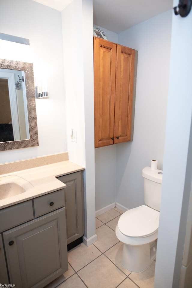 bathroom featuring tile patterned floors, toilet, and vanity