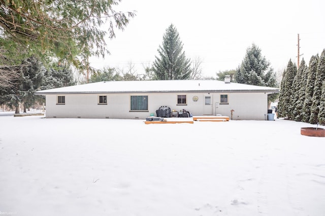 view of snow covered rear of property