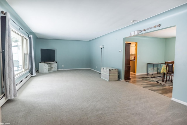 living room with carpet floors and a baseboard heating unit