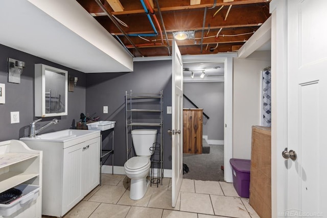 bathroom featuring tile patterned flooring, vanity, and toilet