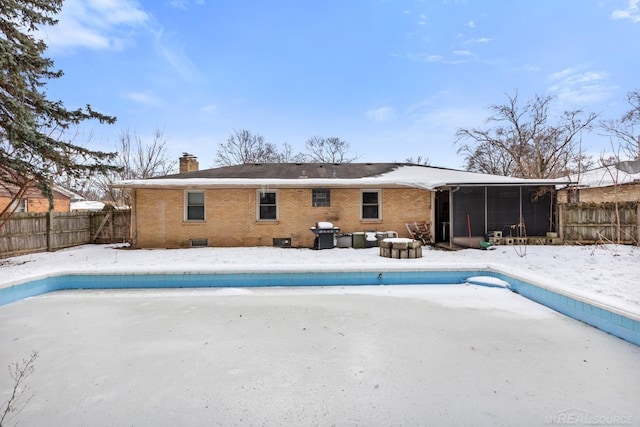 view of pool featuring a sunroom and grilling area