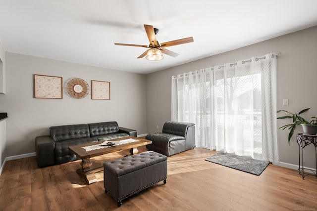 living room featuring hardwood / wood-style flooring and ceiling fan