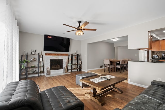 living room with ceiling fan and light wood-type flooring