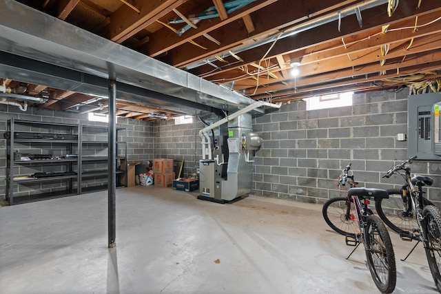 basement with electric panel and heating unit