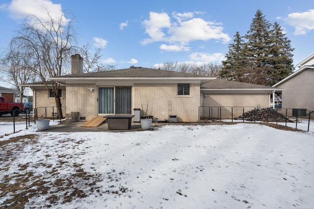 snow covered property with cooling unit