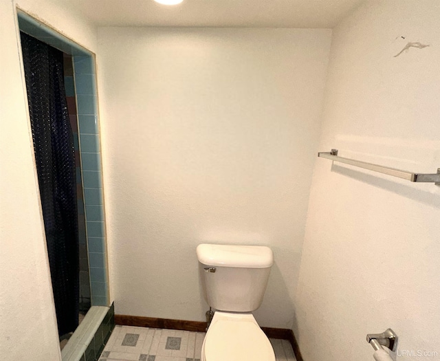 bathroom with walk in shower and toilet