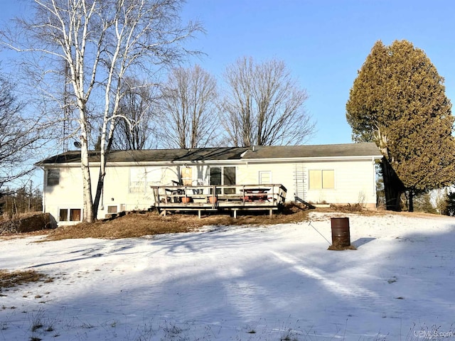 snow covered property featuring a wooden deck