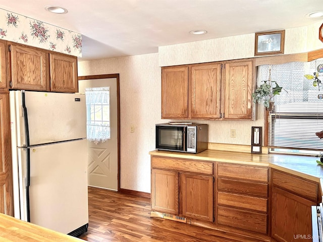 kitchen featuring white fridge, plenty of natural light, and light hardwood / wood-style flooring