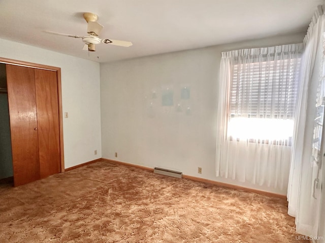 unfurnished bedroom with ceiling fan, carpet flooring, and a closet