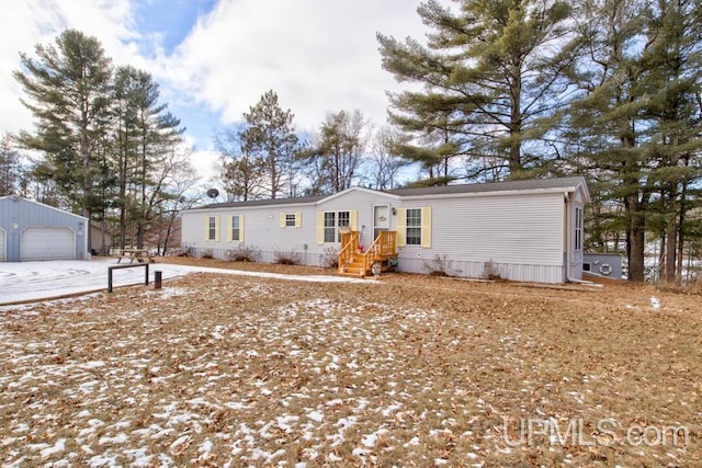 view of front of property with a garage and an outdoor structure