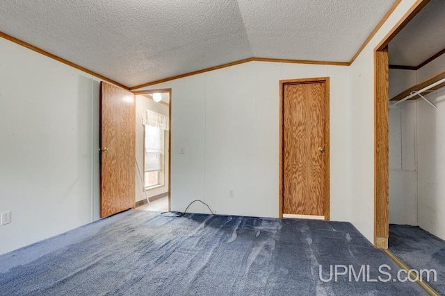 unfurnished bedroom with crown molding, lofted ceiling, carpet, and a textured ceiling