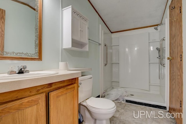 bathroom with vanity, ornamental molding, toilet, and walk in shower