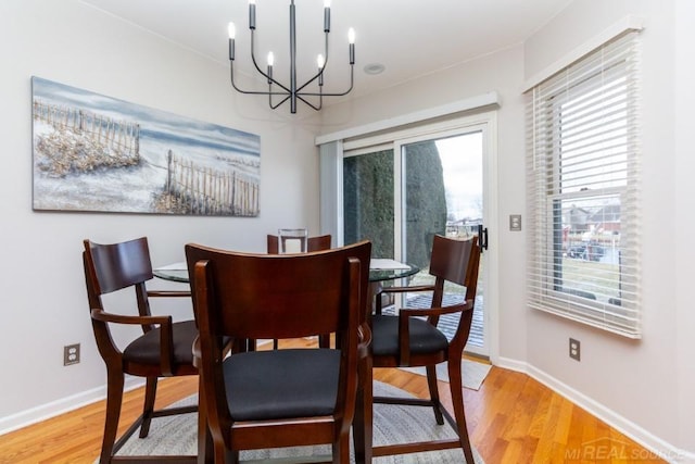 dining space featuring a notable chandelier and light hardwood / wood-style floors