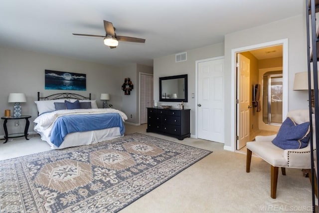 carpeted bedroom with ceiling fan, ensuite bath, and a closet