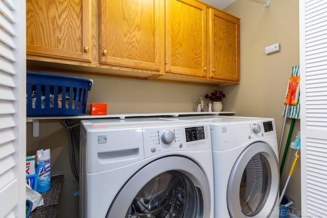 laundry room featuring cabinets and washing machine and dryer