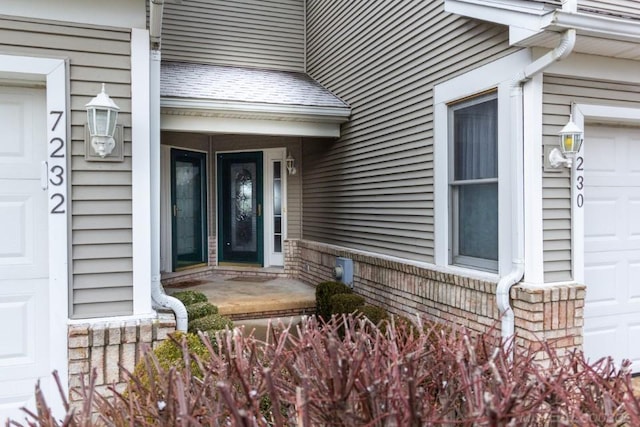 view of exterior entry with a garage