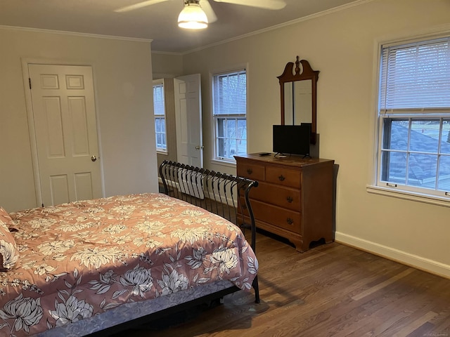 bedroom with crown molding, ceiling fan, dark hardwood / wood-style flooring, and multiple windows