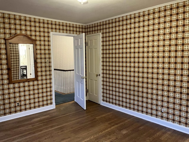 unfurnished bedroom with crown molding and dark hardwood / wood-style floors