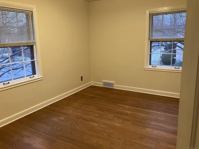 spare room with dark wood-type flooring