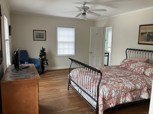 bedroom with hardwood / wood-style flooring, ornamental molding, and ceiling fan