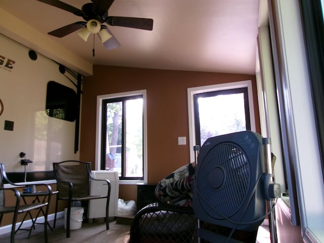 sitting room with ceiling fan, carpet floors, and vaulted ceiling