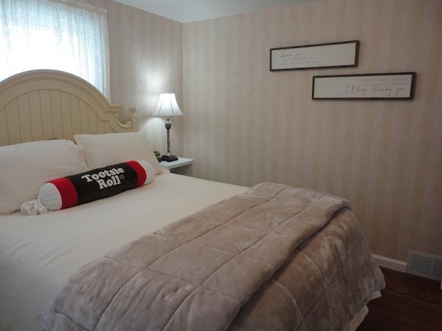 bedroom with dark hardwood / wood-style flooring