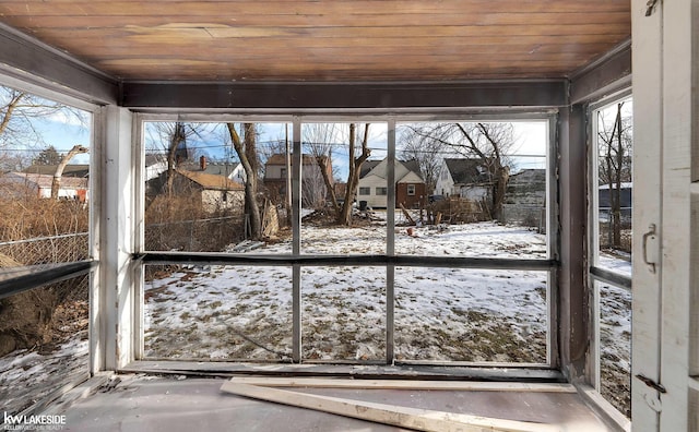 unfurnished sunroom featuring wood ceiling