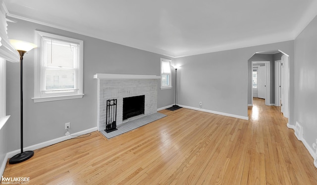 unfurnished living room featuring light wood-type flooring and a fireplace