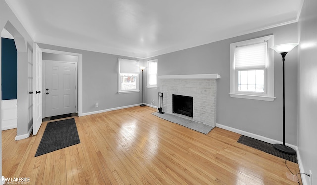 unfurnished living room featuring a fireplace and light wood-type flooring