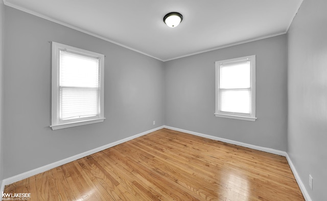 unfurnished room featuring crown molding and light wood-type flooring