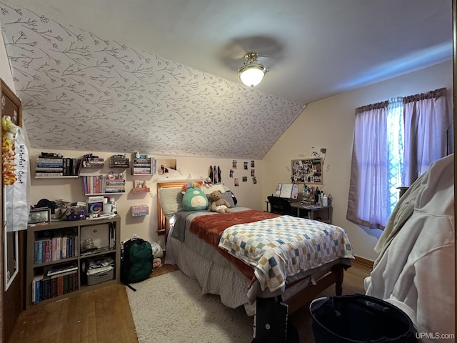 bedroom featuring lofted ceiling and wood-type flooring