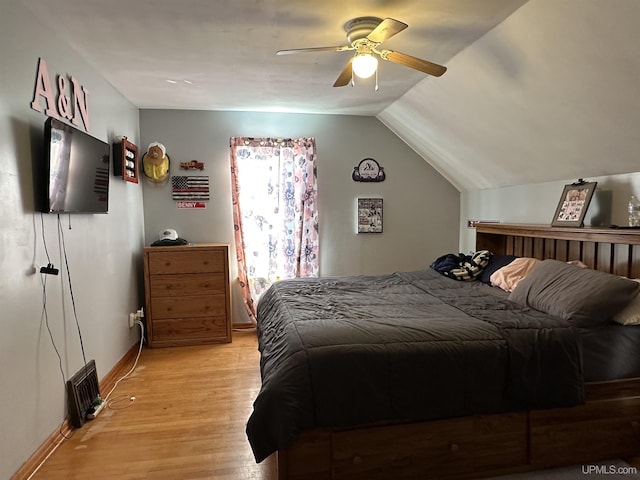 bedroom featuring light hardwood / wood-style flooring, ceiling fan, and vaulted ceiling