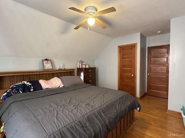 bedroom featuring vaulted ceiling, ceiling fan, and light wood-type flooring