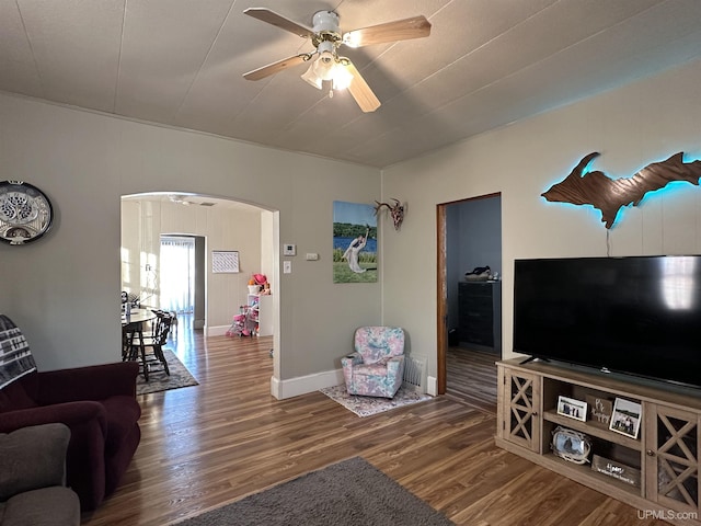 living room with wood-type flooring and ceiling fan